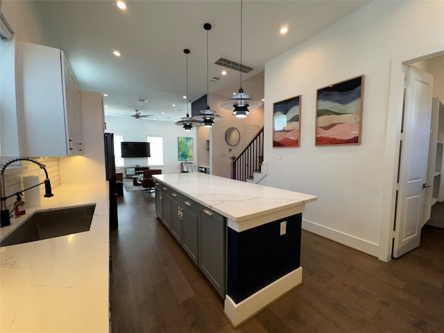 418 Bayou St, Houston, TX 77020 - kitchen featuring a ceiling fan, dark wood-style flooring, light stone countertops, open floor plan, and recessed lighting