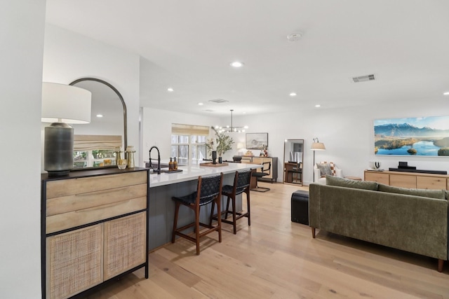 2327 Lamonte Ln, Houston, TX 77018 - living area featuring light wood-style flooring, recessed lighting, and a chandelier