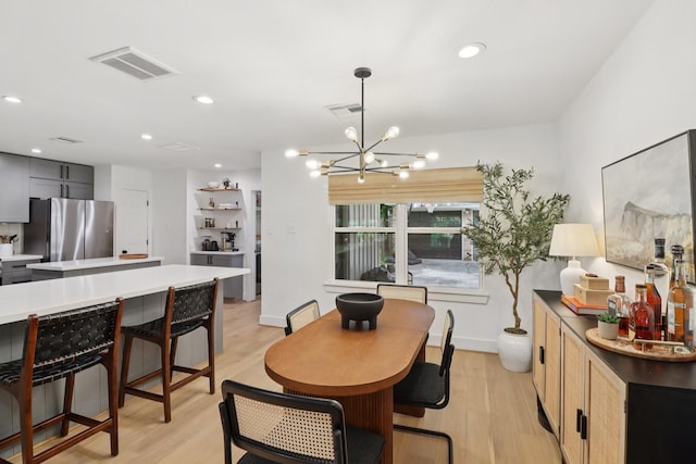 2327 Lamonte Ln, Houston, TX 77018 - dining space with light wood-type flooring, a chandelier, and recessed lighting