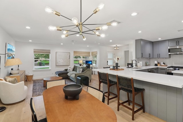 2327 Lamonte Ln, Houston, TX 77018 - dining area with light wood finished floors, recessed lighting, and a chandelier