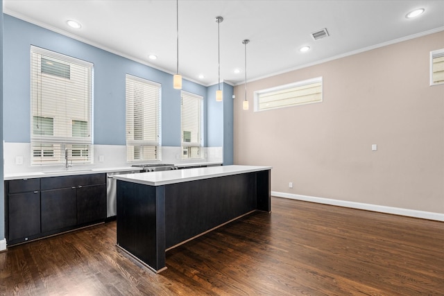 3115 Leeland St, Houston, TX 77003 - kitchen featuring light countertops, crown molding, stainless steel dishwasher, a center island, and dark wood-style flooring