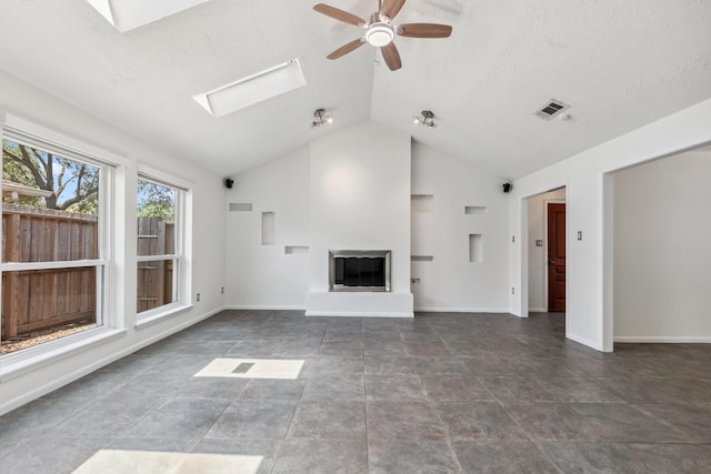 11406 Meadow Lake Dr, Houston, TX 77077 - unfurnished living room with a skylight, a ceiling fan, vaulted ceiling, a glass covered fireplace, and a textured ceiling