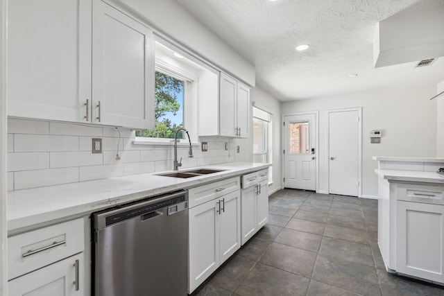 11406 Meadow Lake Dr, Houston, TX 77077 - kitchen featuring dishwasher, a textured ceiling, decorative backsplash, white cabinets, and dark tile patterned floors