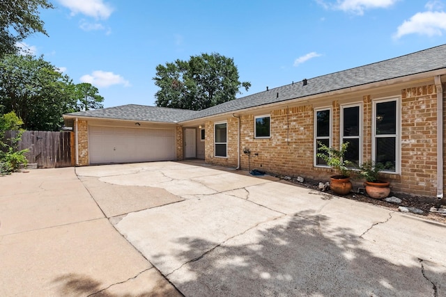 11406 Meadow Lake Dr, Houston, TX 77077 - view of front of property with an attached garage, concrete driveway, a shingled roof, and brick siding