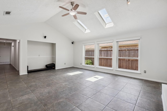 11406 Meadow Lake Dr, Houston, TX 77077 - unfurnished living room featuring lofted ceiling, a ceiling fan, a skylight, dark tile patterned floors, and a textured ceiling