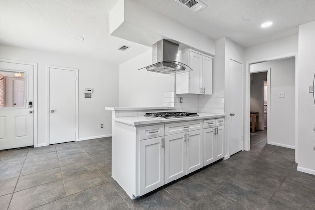 11406 Meadow Lake Dr, Houston, TX 77077 - kitchen with range hood, stainless steel gas stovetop, light countertops, white cabinets, and a textured ceiling