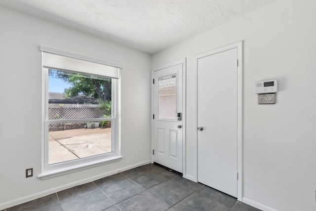 11406 Meadow Lake Dr, Houston, TX 77077 - entryway featuring baseboards and a textured ceiling