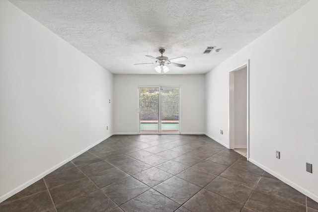 11406 Meadow Lake Dr, Houston, TX 77077 - empty room featuring ceiling fan, a textured ceiling, and dark tile patterned flooring