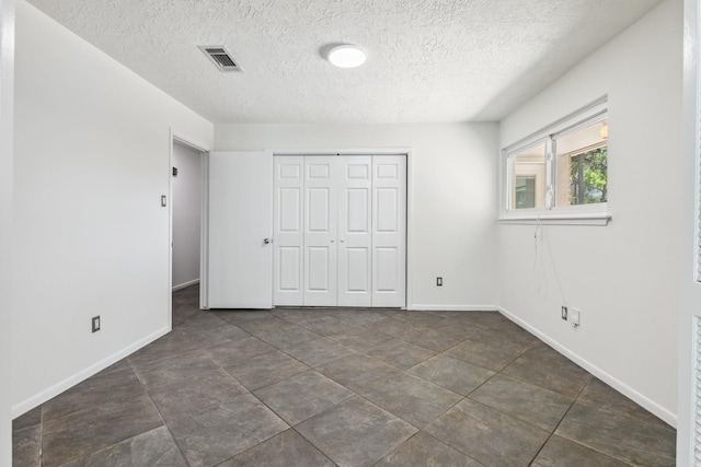 11406 Meadow Lake Dr, Houston, TX 77077 - unfurnished bedroom with a textured ceiling and a closet