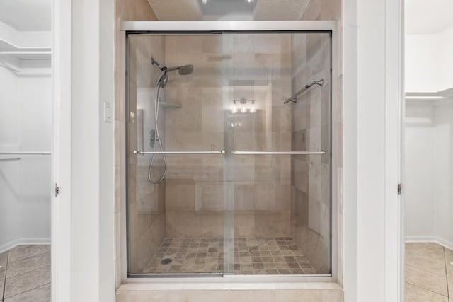 11406 Meadow Lake Dr, Houston, TX 77077 - bathroom with a stall shower, tile patterned flooring, and a spacious closet