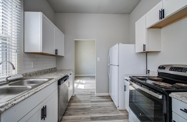 3412 Avenue S, Galveston, TX 77550 - kitchen featuring range with electric cooktop, stainless steel dishwasher, light wood-style flooring, backsplash, and white cabinets