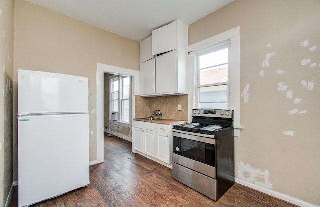 3412 Avenue S, Galveston, TX 77550 - kitchen with freestanding refrigerator, electric stove, dark wood-style floors, and white cabinetry