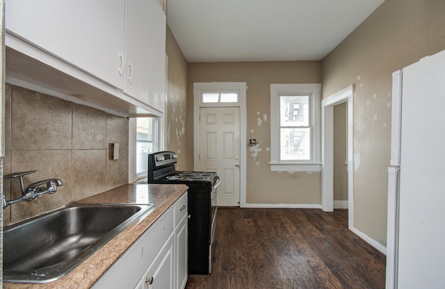 3412 Avenue S, Galveston, TX 77550 - kitchen featuring electric range, freestanding refrigerator, dark wood finished floors, white cabinets, and decorative backsplash