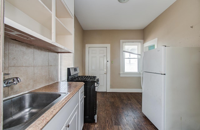 3412 Avenue S, Galveston, TX 77550 - kitchen featuring freestanding refrigerator, stainless steel gas range oven, dark wood-type flooring, open shelves, and white cabinets