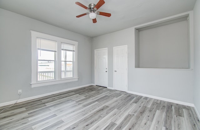 3412 Avenue S, Galveston, TX 77550 - unfurnished bedroom with wood finished floors, a ceiling fan, and two closets