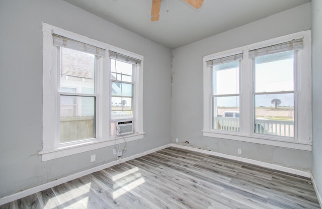 3412 Avenue S, Galveston, TX 77550 - unfurnished room featuring plenty of natural light, cooling unit, and wood finished floors