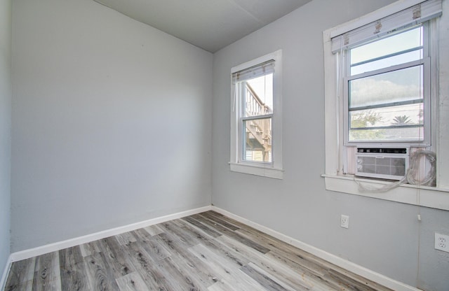 3412 Avenue S, Galveston, TX 77550 - empty room featuring light wood finished floors, cooling unit, and lofted ceiling
