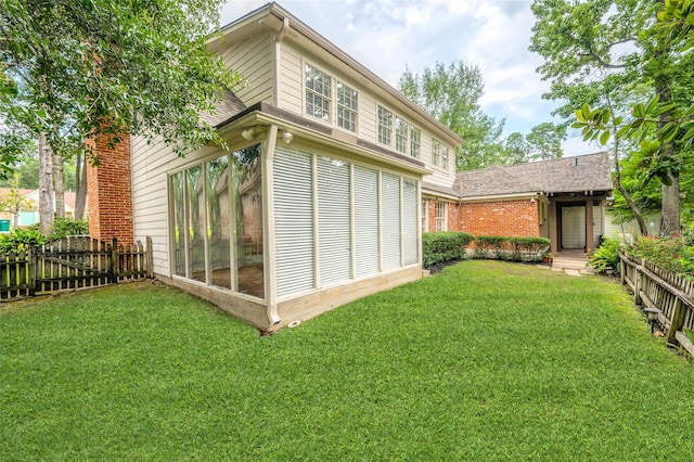 738 Stone Mountain Dr, Conroe, TX 77302 - rear view of house featuring a sunroom, a shingled roof, and brick siding