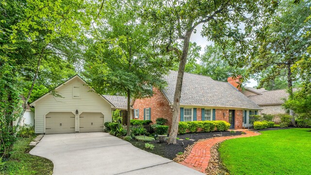 738 Stone Mountain Dr, Conroe, TX 77302 - view of front of property featuring driveway, brick siding, roof with shingles, a front yard, and an attached garage