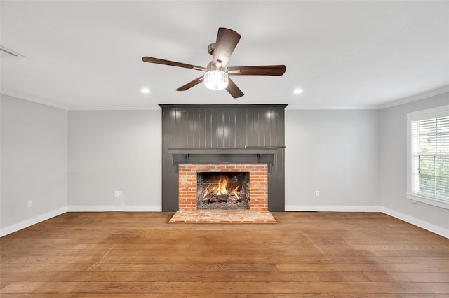 738 Stone Mountain Dr, Conroe, TX 77302 - unfurnished living room with ornamental molding, recessed lighting, ceiling fan, wood finished floors, and a brick fireplace