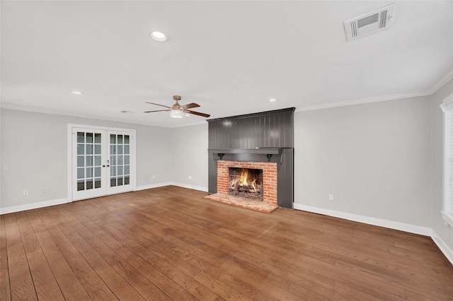 738 Stone Mountain Dr, Conroe, TX 77302 - unfurnished living room with a ceiling fan, a brick fireplace, crown molding, recessed lighting, and hardwood / wood-style flooring