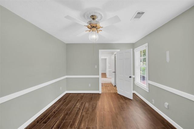 738 Stone Mountain Dr, Conroe, TX 77302 - unfurnished room featuring a ceiling fan and dark wood-style floors