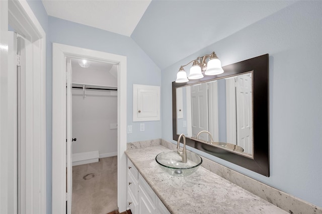 738 Stone Mountain Dr, Conroe, TX 77302 - bathroom featuring vanity, lofted ceiling, and a walk in closet