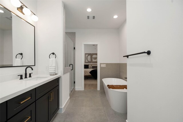 2520 Live Oak St, Houston, TX 77004 - ensuite bathroom featuring vanity, a freestanding bath, recessed lighting, a shower stall, and tile patterned floors