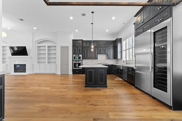 1156 Mosaico Ln, Houston, TX 77055 - kitchen with refrigerator, ornamental molding, a kitchen island, open floor plan, and light countertops
