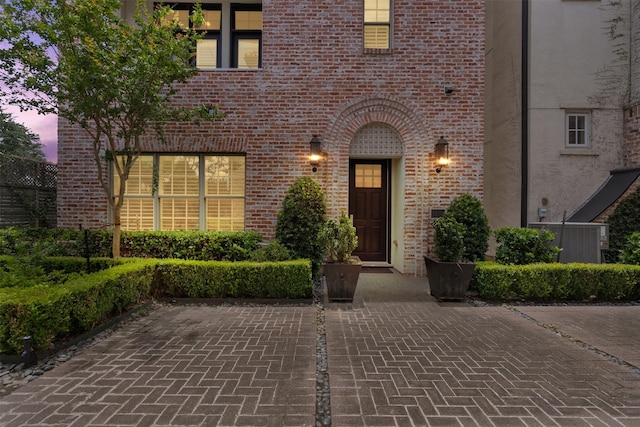 1156 Mosaico Ln, Houston, TX 77055 - exterior entry at dusk featuring brick siding