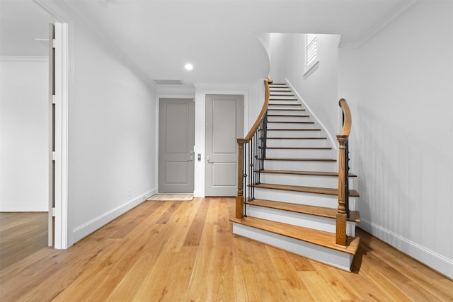 1156 Mosaico Ln, Houston, TX 77055 - stairs featuring wood finished floors, ornamental molding, and recessed lighting