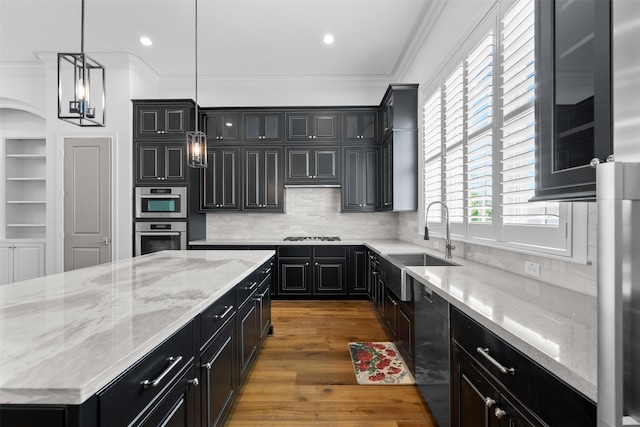 1156 Mosaico Ln, Houston, TX 77055 - kitchen featuring stainless steel appliances, dark cabinets, crown molding, wood finished floors, and backsplash
