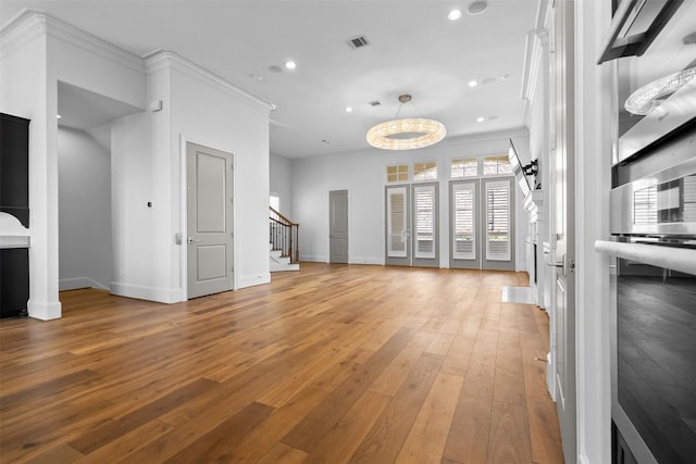 1156 Mosaico Ln, Houston, TX 77055 - unfurnished living room with stairway, recessed lighting, crown molding, and light wood-type flooring