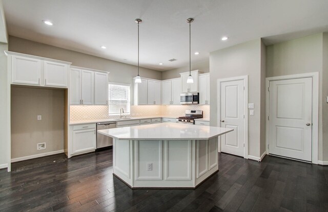6914 N Elmwood Trl, Katy, TX 77493 - kitchen featuring appliances with stainless steel finishes, white cabinetry, dark wood-type flooring, backsplash, and recessed lighting