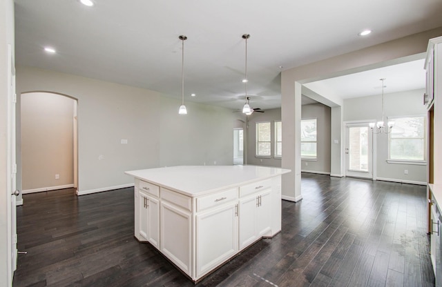 6914 N Elmwood Trl, Katy, TX 77493 - kitchen featuring arched walkways, open floor plan, dark wood-type flooring, decorative light fixtures, and recessed lighting