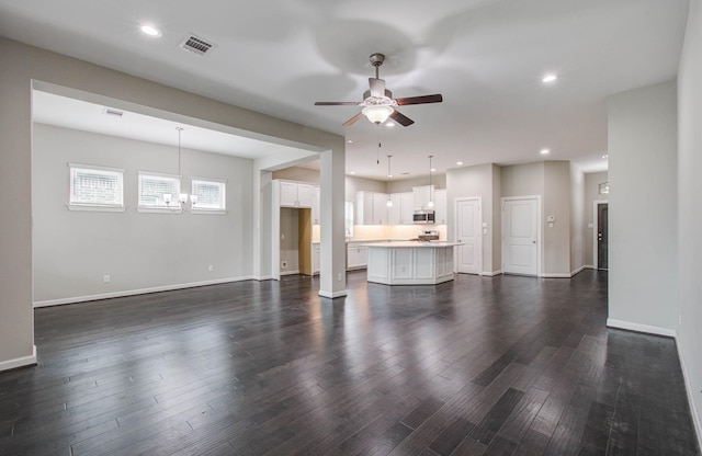 6914 N Elmwood Trl, Katy, TX 77493 - unfurnished living room with ceiling fan, dark wood-style floors, a chandelier, and recessed lighting