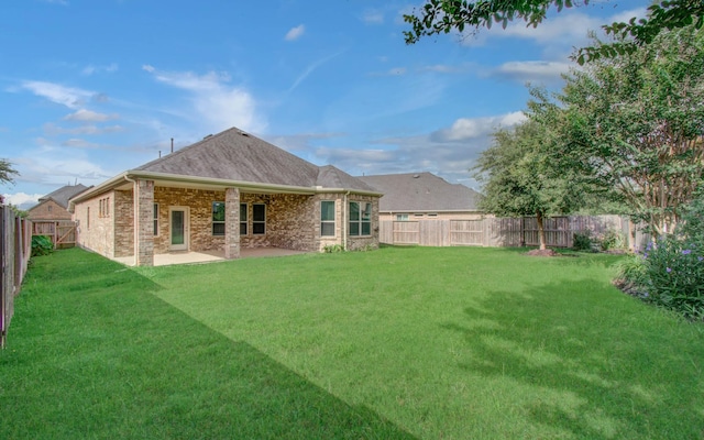 6914 N Elmwood Trl, Katy, TX 77493 - back of property with a fenced backyard, a patio area, brick siding, and roof with shingles