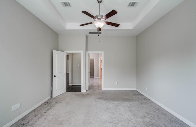 6914 N Elmwood Trl, Katy, TX 77493 - unfurnished bedroom featuring carpet flooring, a raised ceiling, and ceiling fan