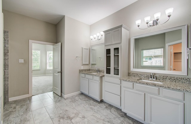 6914 N Elmwood Trl, Katy, TX 77493 - bathroom featuring a chandelier, two vanities, and marble finish floors