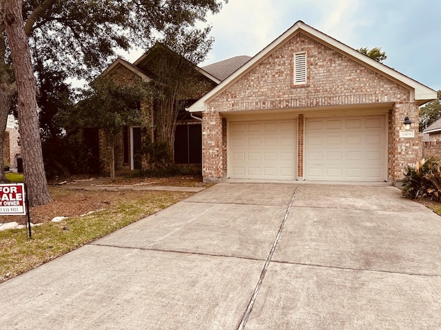 2606 Iris Ct, Pearland, TX 77584 - view of front facade featuring concrete driveway, an attached garage, and brick siding