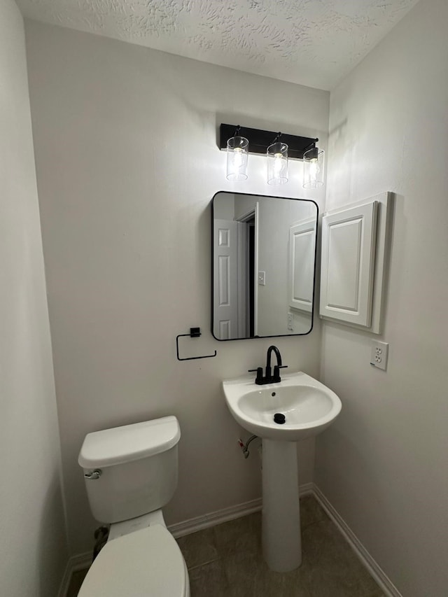 2606 Iris Ct, Pearland, TX 77584 - half bath with a textured ceiling and tile patterned floors
