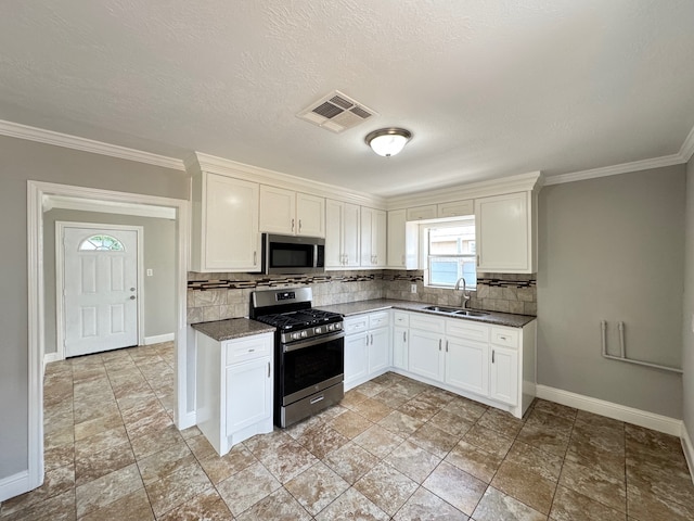 1013 E 40th St, Houston, TX 77022 - kitchen featuring stainless steel appliances, decorative backsplash, dark countertops, crown molding, and white cabinetry