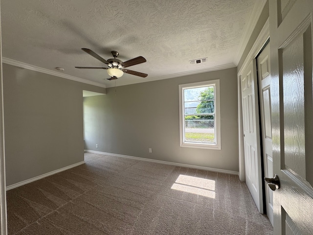 1013 E 40th St, Houston, TX 77022 - empty room with a ceiling fan, carpet flooring, crown molding, and a textured ceiling