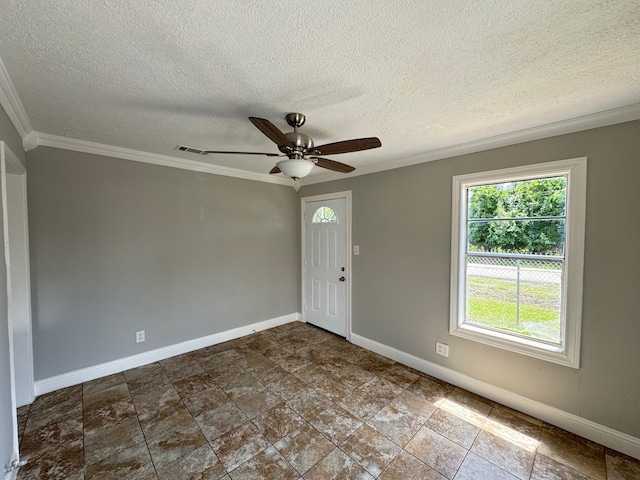 1013 E 40th St, Houston, TX 77022 - empty room with healthy amount of natural light, ornamental molding, a textured ceiling, ceiling fan, and dark stone finish floors