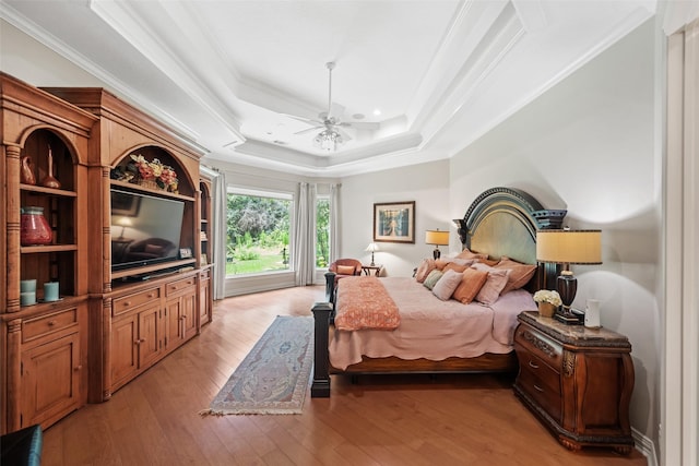 7417 Teaswood Dr, Conroe, TX 77304 - bedroom featuring light wood-type flooring, crown molding, a tray ceiling, and recessed lighting