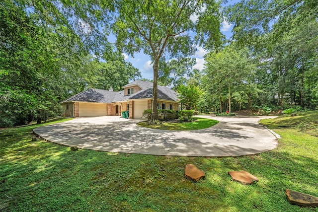 7417 Teaswood Dr, Conroe, TX 77304 - view of front of property featuring a garage, a front yard, and concrete driveway