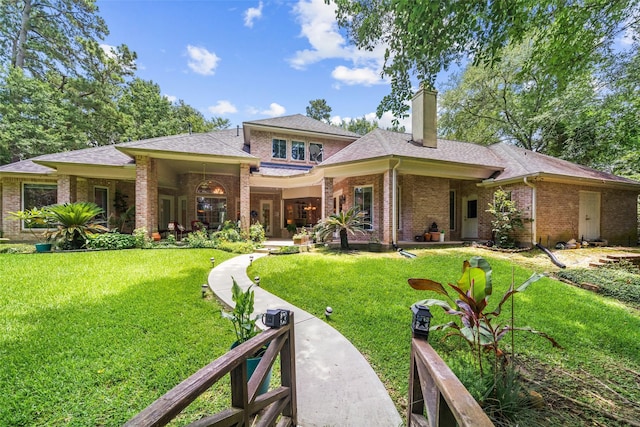 7417 Teaswood Dr, Conroe, TX 77304 - rear view of property featuring a chimney, brick siding, a yard, and a shingled roof