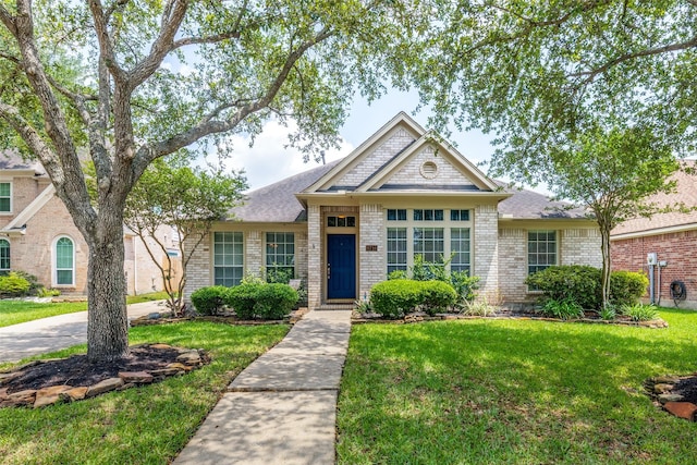 8710 Candleshine Cir, Houston, TX 77095 - view of front of house with a front yard, brick siding, and roof with shingles