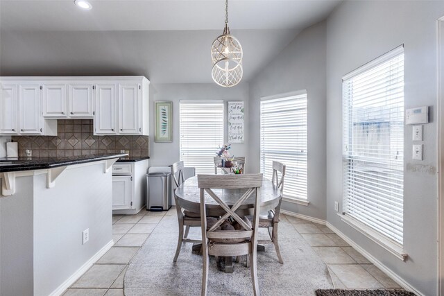 8710 Candleshine Cir, Houston, TX 77095 - dining space with light tile patterned flooring, lofted ceiling, plenty of natural light, recessed lighting, and a chandelier