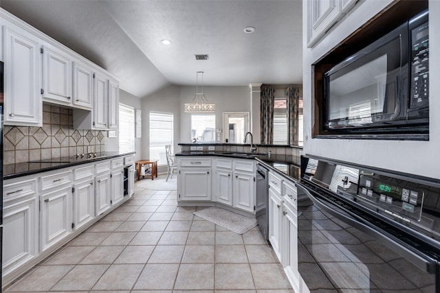 8710 Candleshine Cir, Houston, TX 77095 - kitchen with black appliances, dark countertops, vaulted ceiling, decorative backsplash, and a peninsula